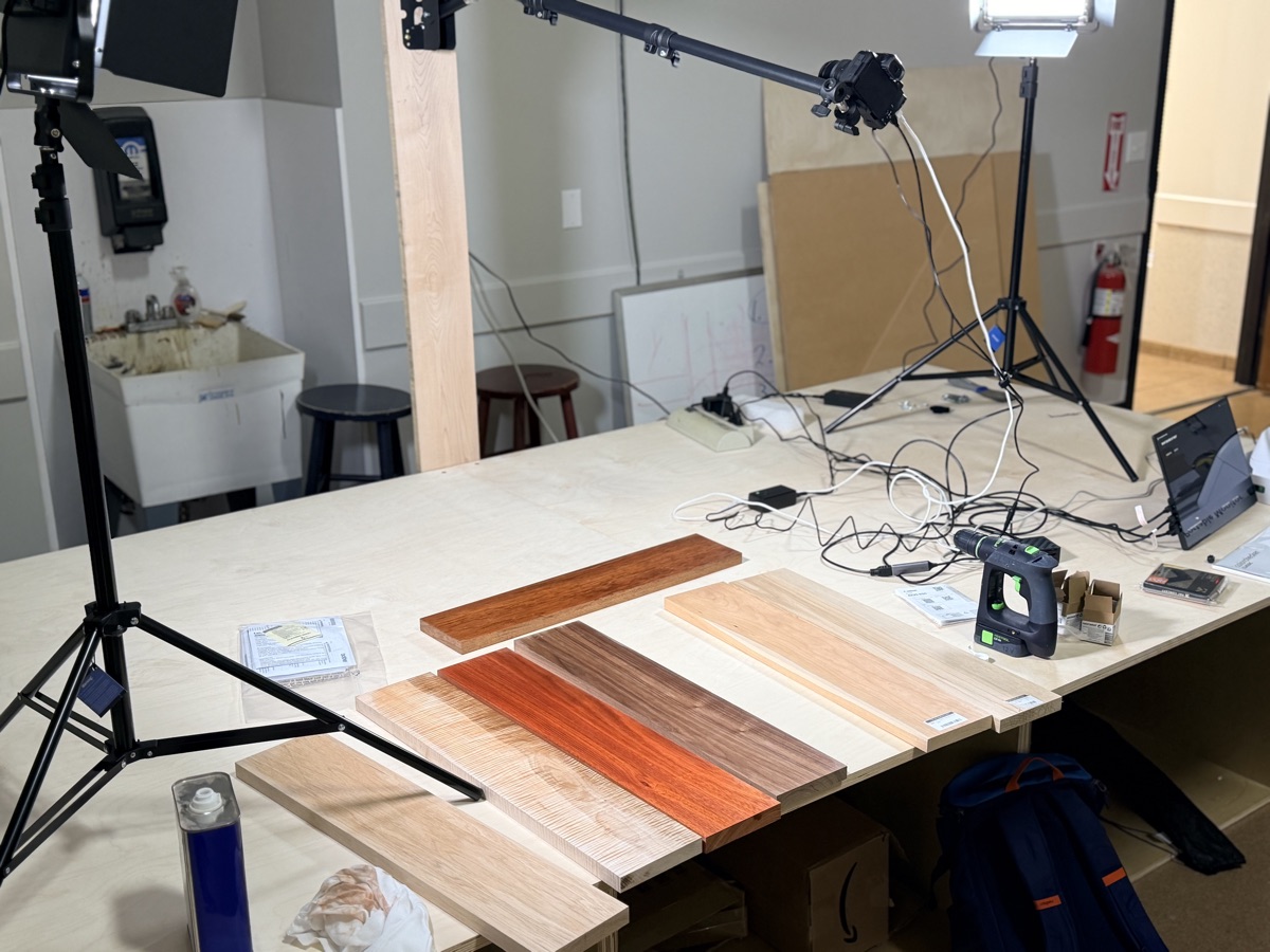 A photo booth with several exotic hardwood boards being laid out to be photographed. 